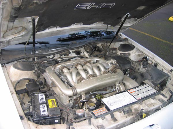 The 3.0 liter V-6 Yamaha engine from the 1991 SHO Ford Taurus showing the engine bay of the vehicle and the long intake runners of the transverse engine