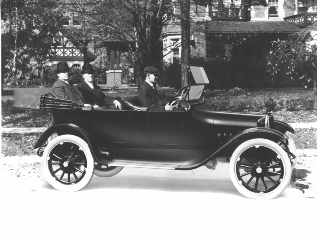 Black top down 1915 Dodge Model 30-35 with John and Horace Dodge seated in rear